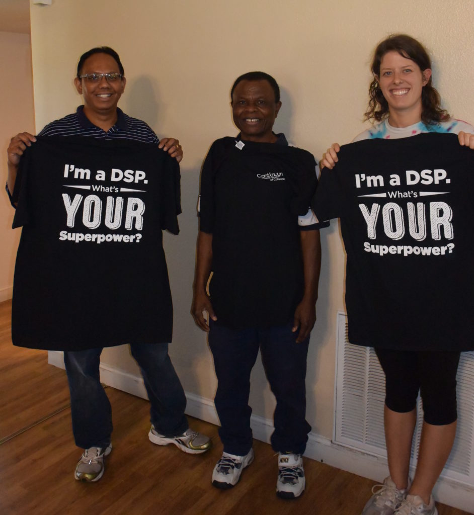 3 Direct Service Providers standing holding up Im a DSP provider black tshirts